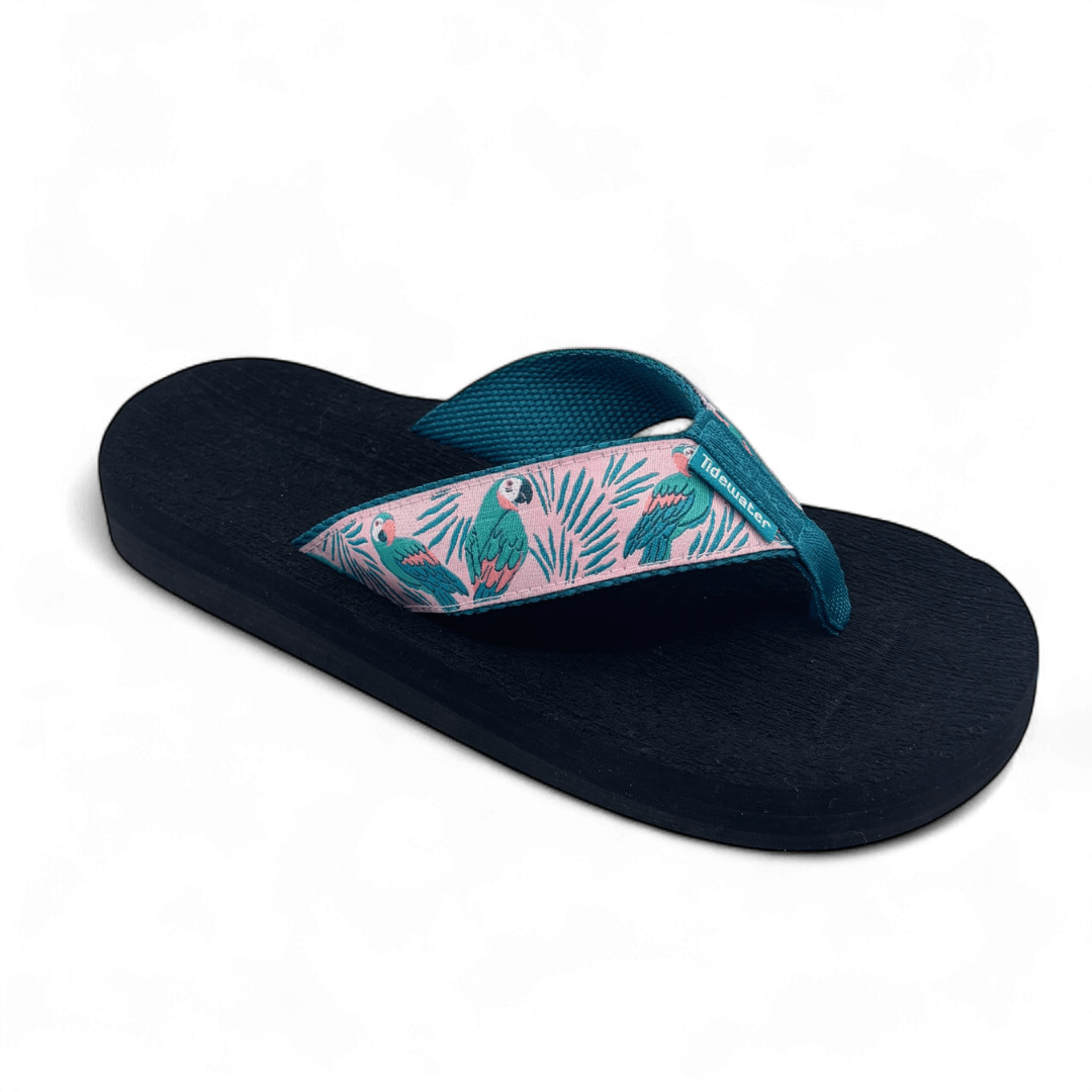 Flip flop with black footbed and pink straps featuring teal parrots and palm leaves, designed for comfort with teal woven lining