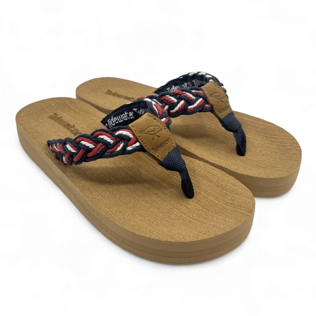 Pair of flip flops with tan comfort footbed and braided red, white, and blue straps with leather accent and contoured shape